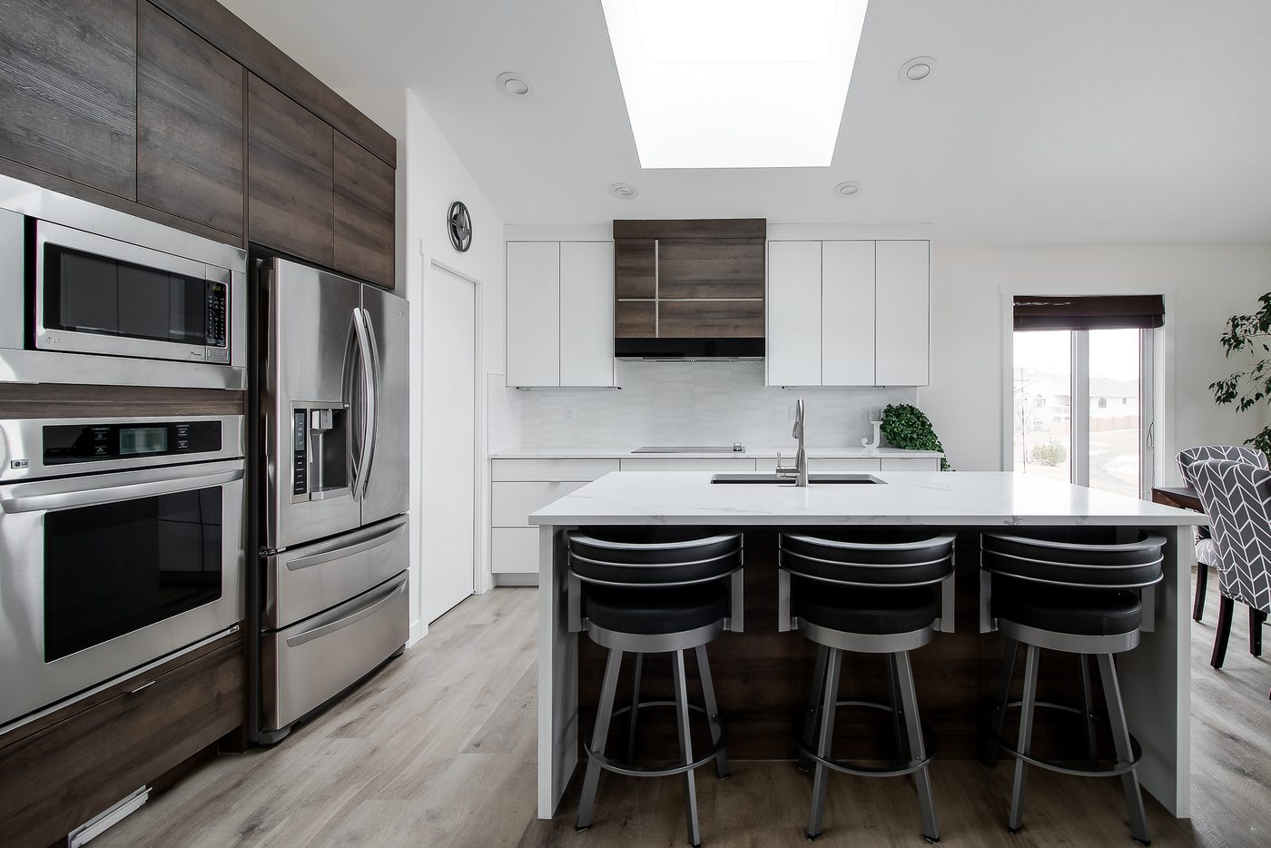 Kitchen with built-in ovens and island seating